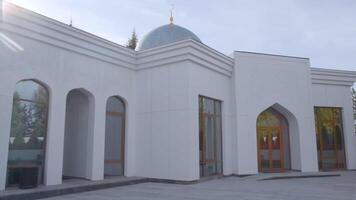 Exterior of a white mosque, concept of religion and architecture. Scene. Beautiful building with big windows. video