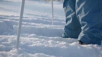 A boy skiing. Creative. A child who stands in the white snow and holds big sticks. video