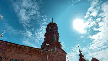 Low angle view of a tower building on bright blue sky background. Clip. Concept of architecture. video
