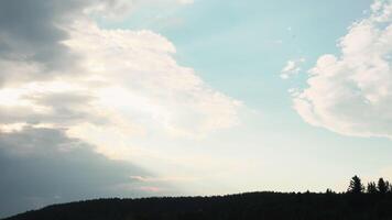 Breathtaking sky with clouds above green forest. Media. Summer landscape with sun rays shining through the clouds. video