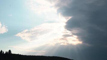 Breathtaking sky with clouds above green forest. Media. Summer landscape with sun rays shining through the clouds. video