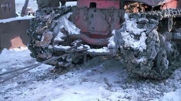 Tow truck with dirty tractor in winter. Clip. Close-up of tractor with mud and snow on winter road. Tow rope tied to tractor in winter video