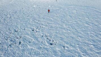 Winter desert with a walking tourist. Clip. A man in warm clothes with an empty desert in subzero temperatures. video