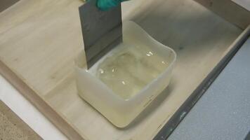 Analysis of plate in solution. Clip. Close-up of man in office oxidizes metal plate. Oxidation or analysis of metal plate in solution video