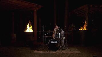 A man at a party playing musical instruments. Clip. A young creative man playing percussion instruments in the night. video