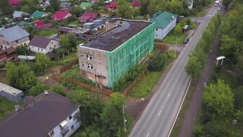 Aerial view of a town on a sunny autumn evening. Clip. Village with small streets and green trees. video