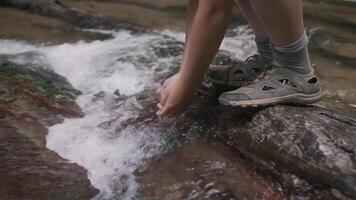 Close up of boy drinking water from his hands of creek in slow motion. Creative. Boy and mountainous cold stream. video