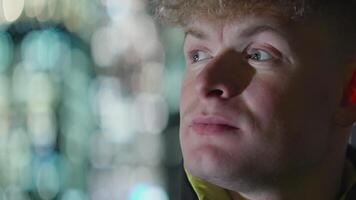 Portrait of a surprised man. A young emotional man with big green eyes looks to the right side. video