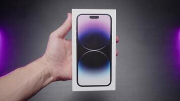 New iPhone 14. Action. Buying a packed black phone that is held in your hands. Use only for editorial. video