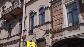 View of driving car on how to go home in summer. Action. Windows and facades of buildings in old European city. Driving down street with windows of old houses in summer video