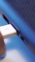 Close up of hand putting USB cable into external hard disk isolated on white background. Media. USB cable for transfering data from others device to computer, accessories for work, social network. video