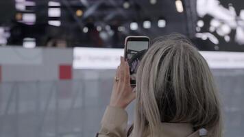A woman deeply engaged in photographing a lively event. Clip. Capturing the Essence of the Moment at a Live Event for Everyone to Experience and Enjoy video