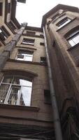 Ancient high courtyard on bright sky background. Action. Typical architecture of St. Petersburg, bottom view of an old beautiful round houses. video