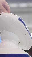 Man stroking robot like pet. Media. Close-up of human hand stroking head of robot dog. New futuristic robots in form of Pets video