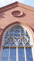 Cathedral of the Immaculate Conception. Action. Catholic church in Moscow made of red bricks with a large beautiful window, concept of religion and architecture. video