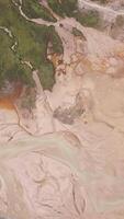 Aerial view of the lime quarry on the sunny summer morning. Clip. Top view of picturesque abandoned flooded quarry surrounded by green forest. video