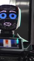 Futuristic robot with electronic face. Media. Funny talking robot with cute facial expression. Futuristic robots at exhibition of new technologies of future video