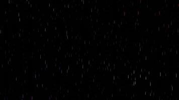 Black background with rain of glitter. Design. Light small parts of brilliance crumbling in different directions in abstraction. video