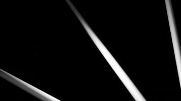 Abstract rays and flying tubes on a black background. Design. Colorful narrow rays becoming tubes. video