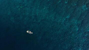 Kayaking in blue ocean on transparent kayak. Drone top down view video