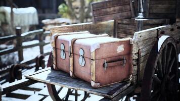 Vintage travel trunks placed on a wooden cart at a rustic outdoor location video