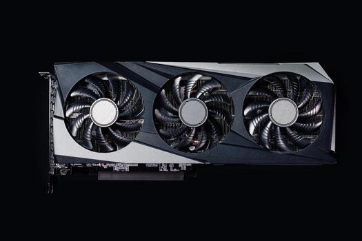 Close-up of high-performance graphics card with three cooling fans on dark background. Modern card for gaming and advanced computing photo
