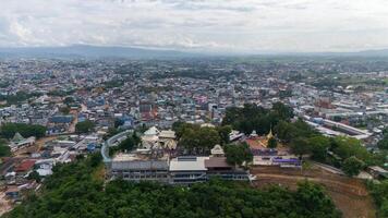 Aerial view of Wat Phrathat Doi Wao temple with Mae Sai downtown in the background. Mae Sai is the northern point in Thailand at the border to Myanmar. photo