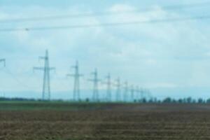 High voltage towers with sky background. Power line support with wires for electricity transmission. High voltage grid tower with wire cable at distribution station. Energy industry, energy saving photo