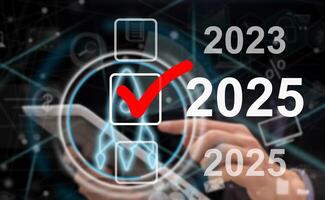 Market trend for 2025. Businessman touching virtual number 2025 for Merry christmas and happy new year concept. End of the old year and start of new business in 2025. photo