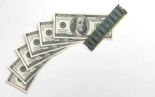 Computer CPU and memory chips on US dollar banknotes background. The high cost of microelectronics concept photo