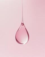 Pink Liquid Droplet Hanging Against Soft Background photo