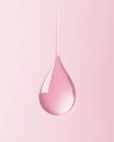 A single pink droplet of liquid, gracefully hanging against a muted, soft background photo