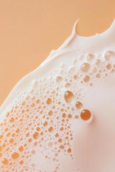 Foamy Skincare Lather with Bubbles Close-Up. A close-up view of foamy skincare lather with delicate bubbles on a soft peach background, highlighting its light and airy texture. photo