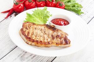 Grilled pork steak with ketchup photo