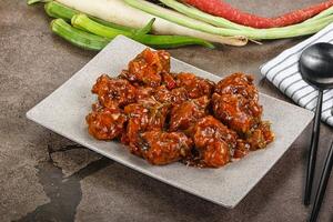 Manchurian chicken with sauce and spices photo