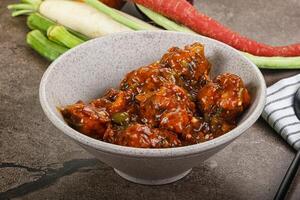 Manchurian chicken with sauce and spices photo