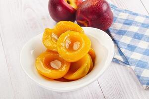 Canned peaches with sweet syrope photo