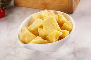 Crushed parmesan cheese in the bowl photo