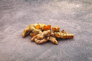 Fresh young Tumeric root heap photo