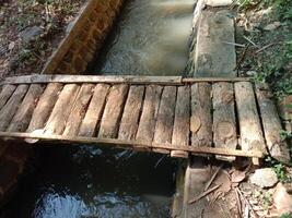 small wooden bridge for cross the canal photo