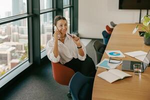 A dedicated businesswoman collaborating effectively with colleagues in a modern office photo