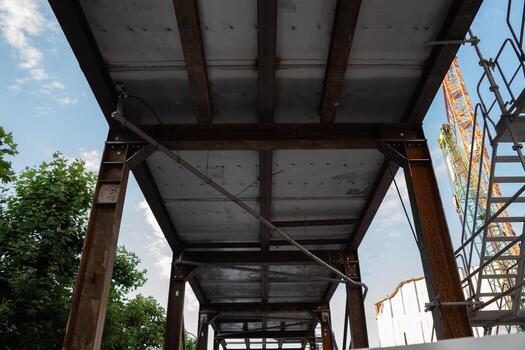 A minimalist urban scene showcasing a construction site with a towering crane. Highlights the intersection of infrastructure, development, and modern architecture under a clear sky. photo
