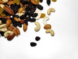 Mixed Nuts Almonds, Walnuts, Cashews, Hazelnuts, Dried Prunes and Raisins. Different Nut Mix. Various Nuts and Dried Fruits on white background. photo