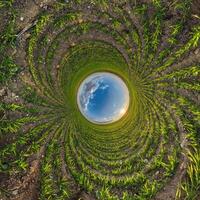 blue hole sphere or globe little planet inside green dry grass frame background photo