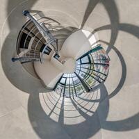 abstractly twisted into spherical 360 panorama interior of modern office with hall staircase and panoramic windows photo