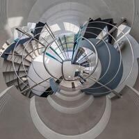 abstractly twisted into spherical 360 panorama interior of modern office with hall staircase and panoramic windows photo