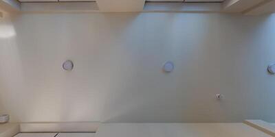 suspended ceiling with halogen spots lamps and drywall construction in empty room in apartment or house. Stretch ceiling white and complex shape. photo