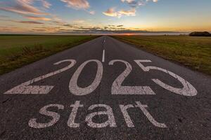numbers 2025 and start on asphalt road highway with cracks with sunrise or sunset sky background. concept of destination in future, freedom, work start, run, planning, challenge, target, new year photo