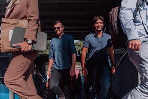 A diverse group of businessmen and colleagues walking together by their workplace, showcasing collaboration and teamwork in the company. photo