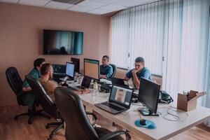 Programmers engrossed in deep collaboration, diligently working together to solve complex problems and develop innovative mobile applications with seamless functionality. photo